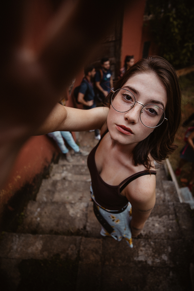 Young woman takes selfie from high angle for cool photo effect