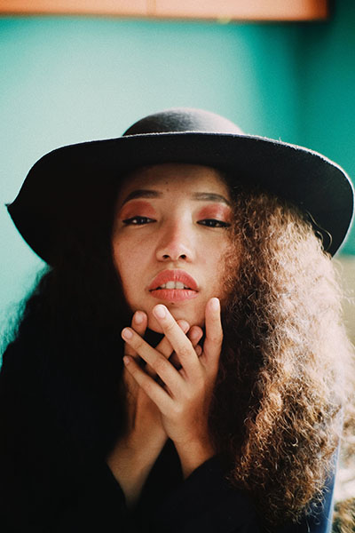 a warm natural light photo of a girl in a hat