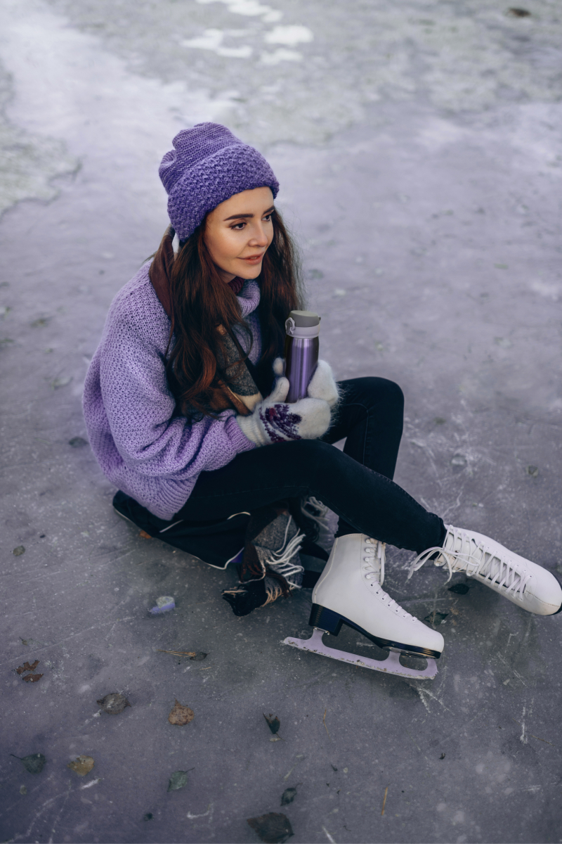  A woman wearing purple sweater and beanie