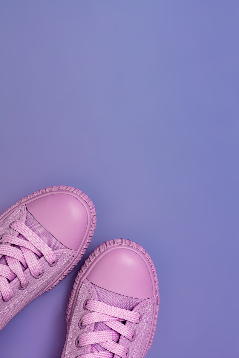 Pink sneakers on the purple background
