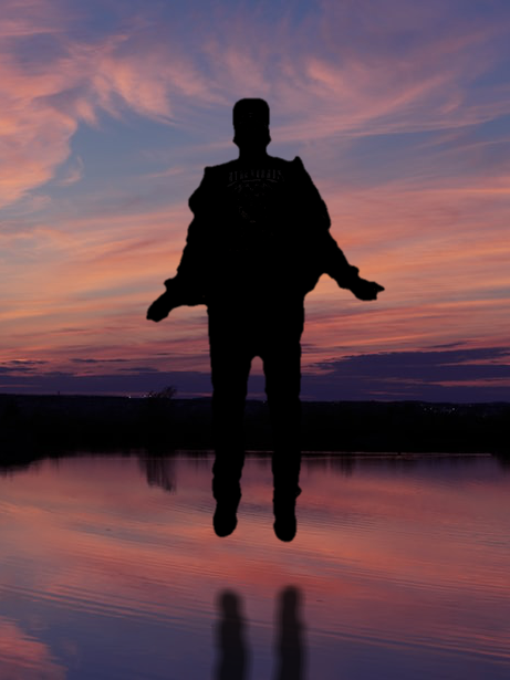 silhouette of man floating over lake